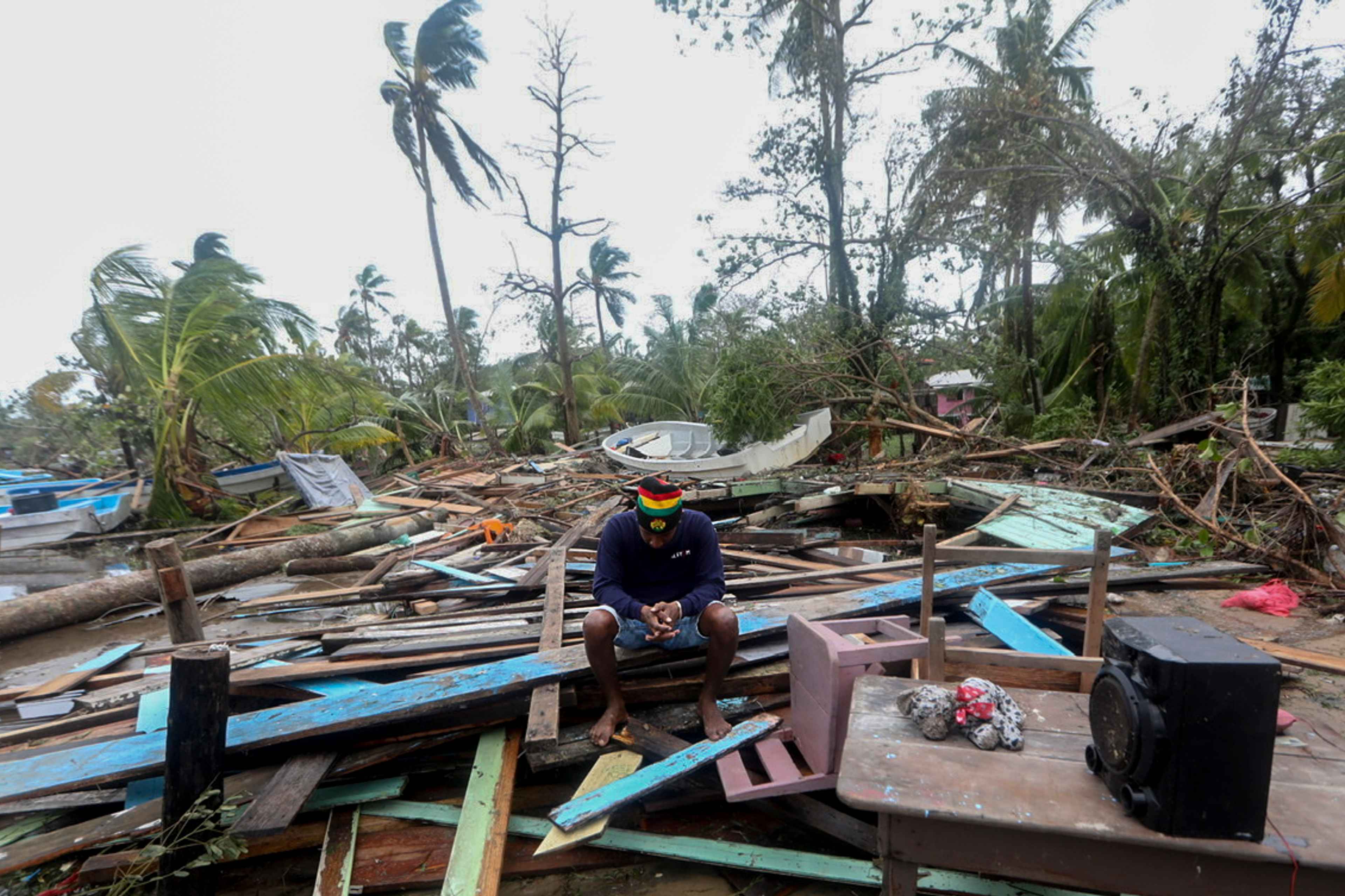 A man reacts as he looks at damages caused by the passage of Hurricane Eta in Puerto Cabezas, Nicaragua, on November 4, 2020. - Hurricane Eta slowed to tropical storm speeds on Wednesday morning even as it pummeled Nicaragua, killing two people there and one in neighboring Honduras, while unleashing fierce winds and heavy downpours. (Photo by Inti OCON / AFP)
