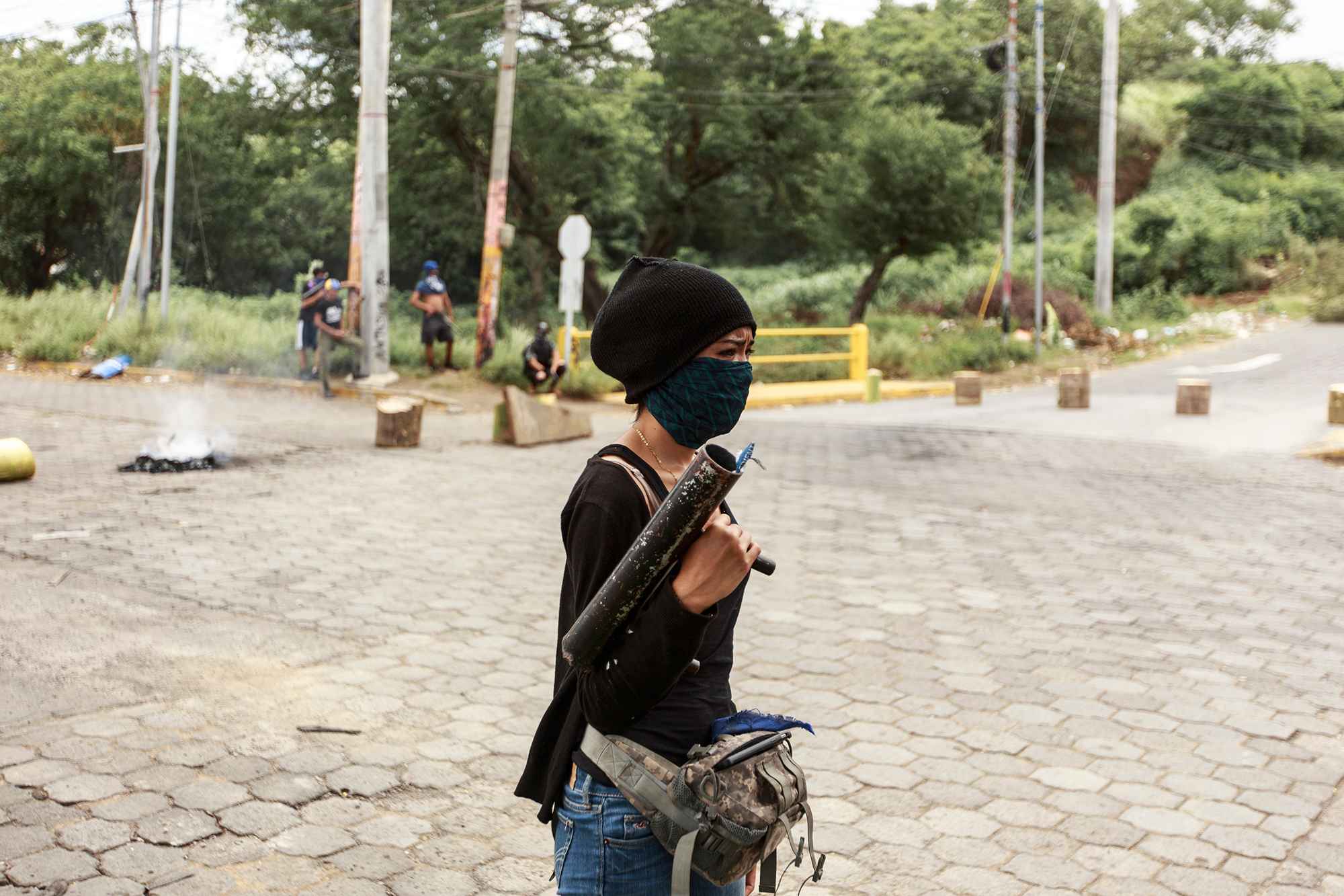 "La Flaca," a member of the besieged students' shock brigade, guards an access point to the university. June 30, 2018.