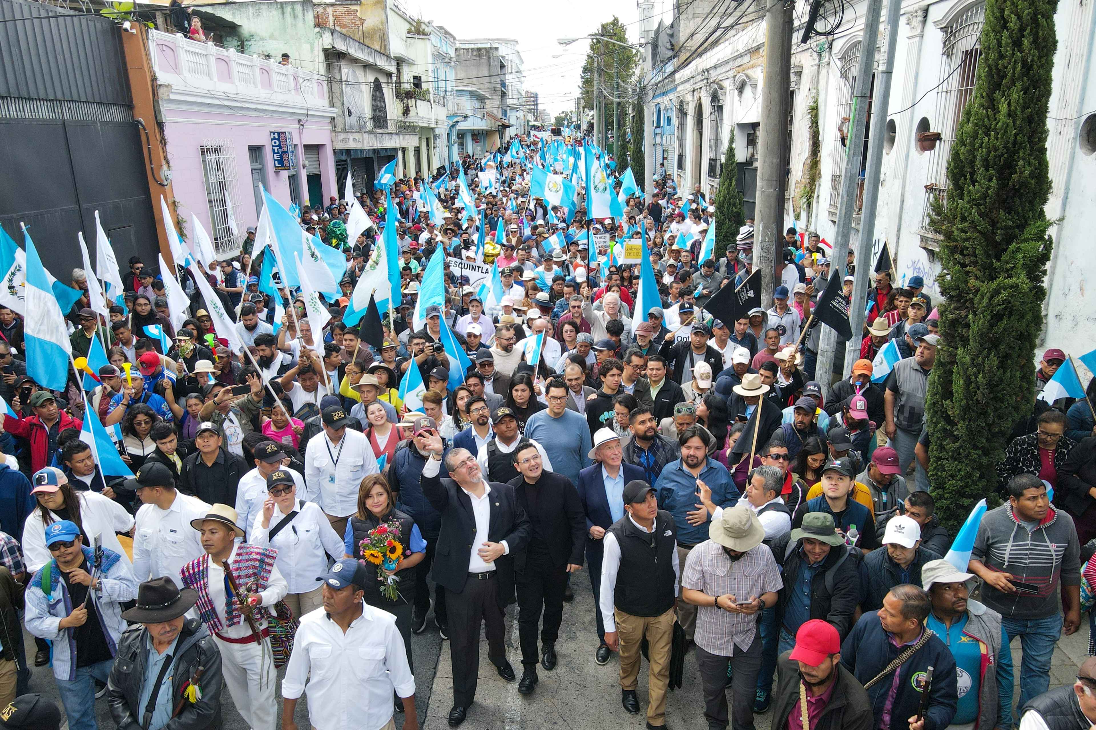 Semilla legislator Samuel Pérez walks alongside Guatemalan President-elect Bernardo Arevalo at the front of the "March for Democracy" to demand the resignation of Attorney General Consuelo Porras in Guatemala City on December 7, 2023. Photo Carlos Alonzo/AFP