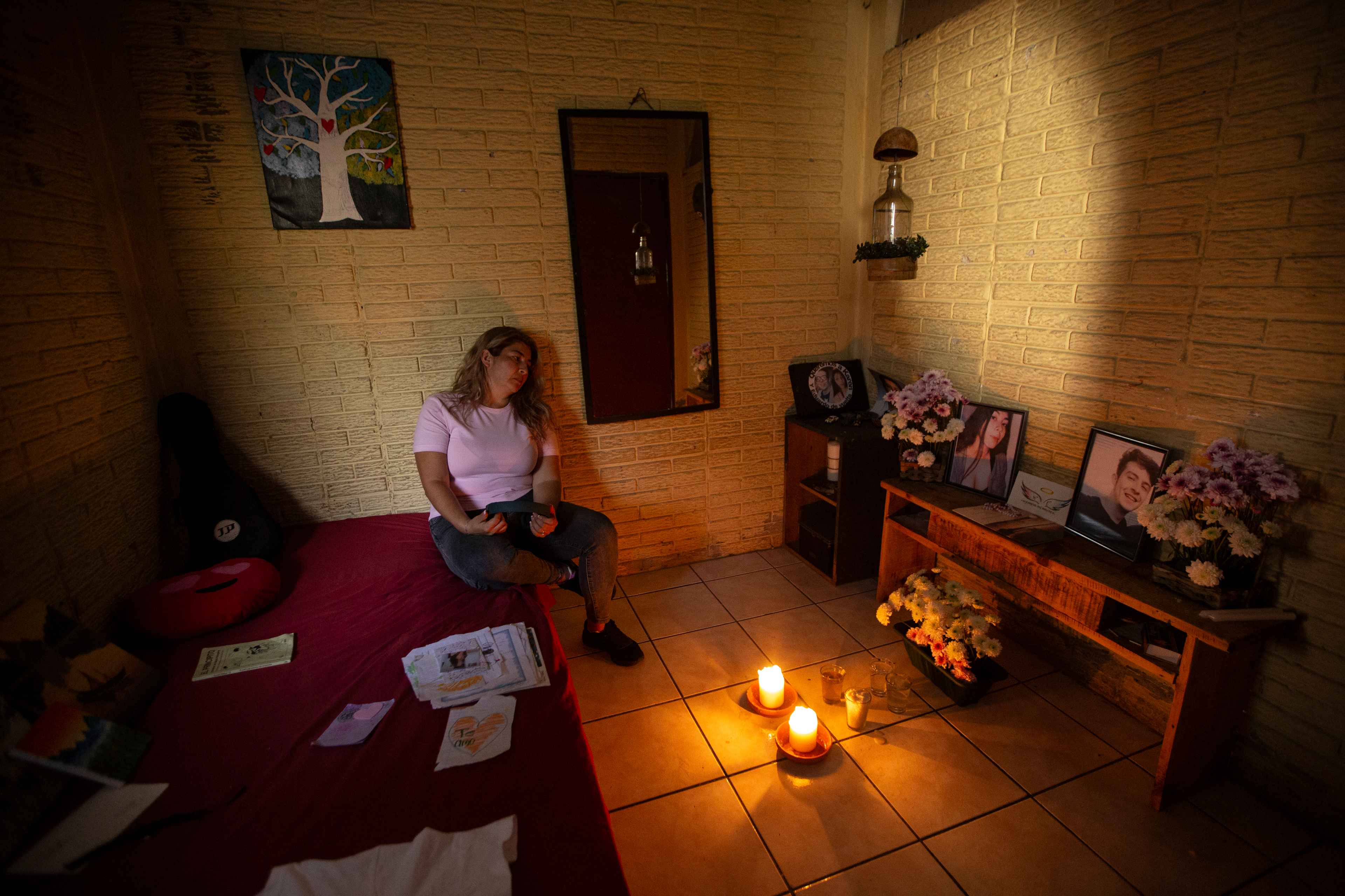 On Sep. 18, 2021, Ivette’s two children, Karen and Eduardo Guerrero, were kidnapped in the Quezaltepec neighborhood of Santa Tecla. She searched for 98 days until their bodies were found on December 23 in a clandestine cemetery in the neighboring municipality of Nuevo Cuscatlán. The case was widely covered by the media. “Officials do not consider the harm they cause,” Ivette says. “For many, my children died because they were gang members and drug traffickers, because that’s the message from the government and from [Security Minister] Gustavo Villatoro.” She says the government politicized her case, which is why she decided not to pursue it with a defense lawyer. She only knows what the prosecutors tell her, because the Attorney General’s Office has declared the case confidential. Ivette, pictured here gazing at an altar in her children’s bedroom, fled El Salvador a few months ago and prefers not to name the country that granted her asylum, where she works in a public hospital kitchen. “After I found my children, the government backed me into a corner. I was not safe anywhere,” she says. “I felt something might happen to me, and not from the gang members who controlled my neighborhood, but because of the attacks from the government to tarnish their image. At least I’m not living in fear anymore. But coming here doesn’t fix my life. It’s hard to survive here too.” Photo by Víctor Peña.