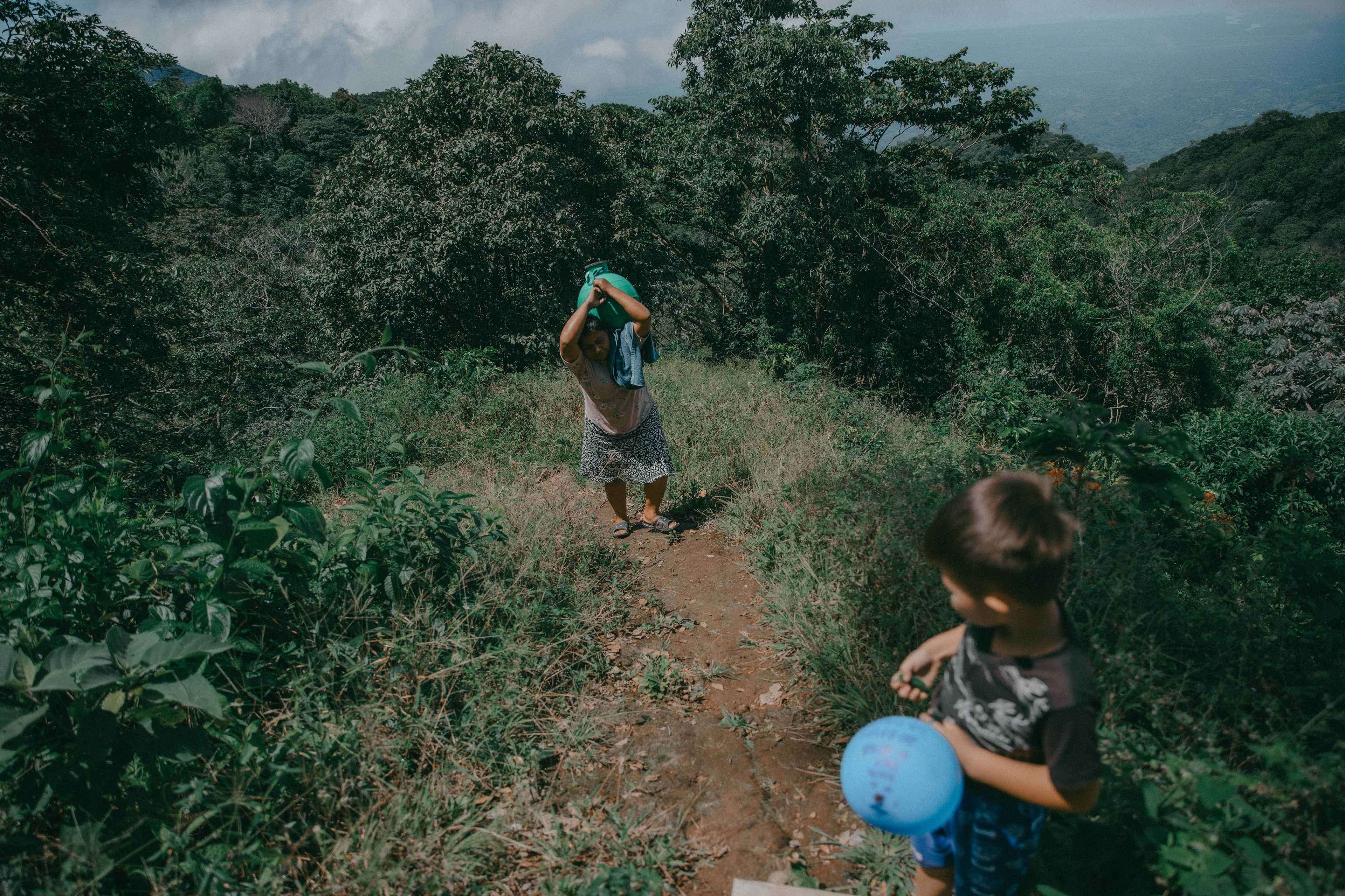 Para conseguir agua, María Aguilar, de 45 años, camina todos los días entre barrancos y pendientes al lado de su sobrino de cinco años. Ella es la encargada de las labores domésticas de su casa, lo que incluye el abastecimiento de agua para consumo y limpieza. Vive junto al resto de su familia en la comunidad San Lorenzo, en la periferia del casco urbano de Berlín. "Imagínese que aquí un hombre que trabaje en el campo gana $60 al mes y, si usted quiere tener agua de la pipa todos los días, al menos es una inversión de $20 semanales. Solo para comprar agua trabajarían los hombres", dijo María mientras subía con un cántaro en su espalda.