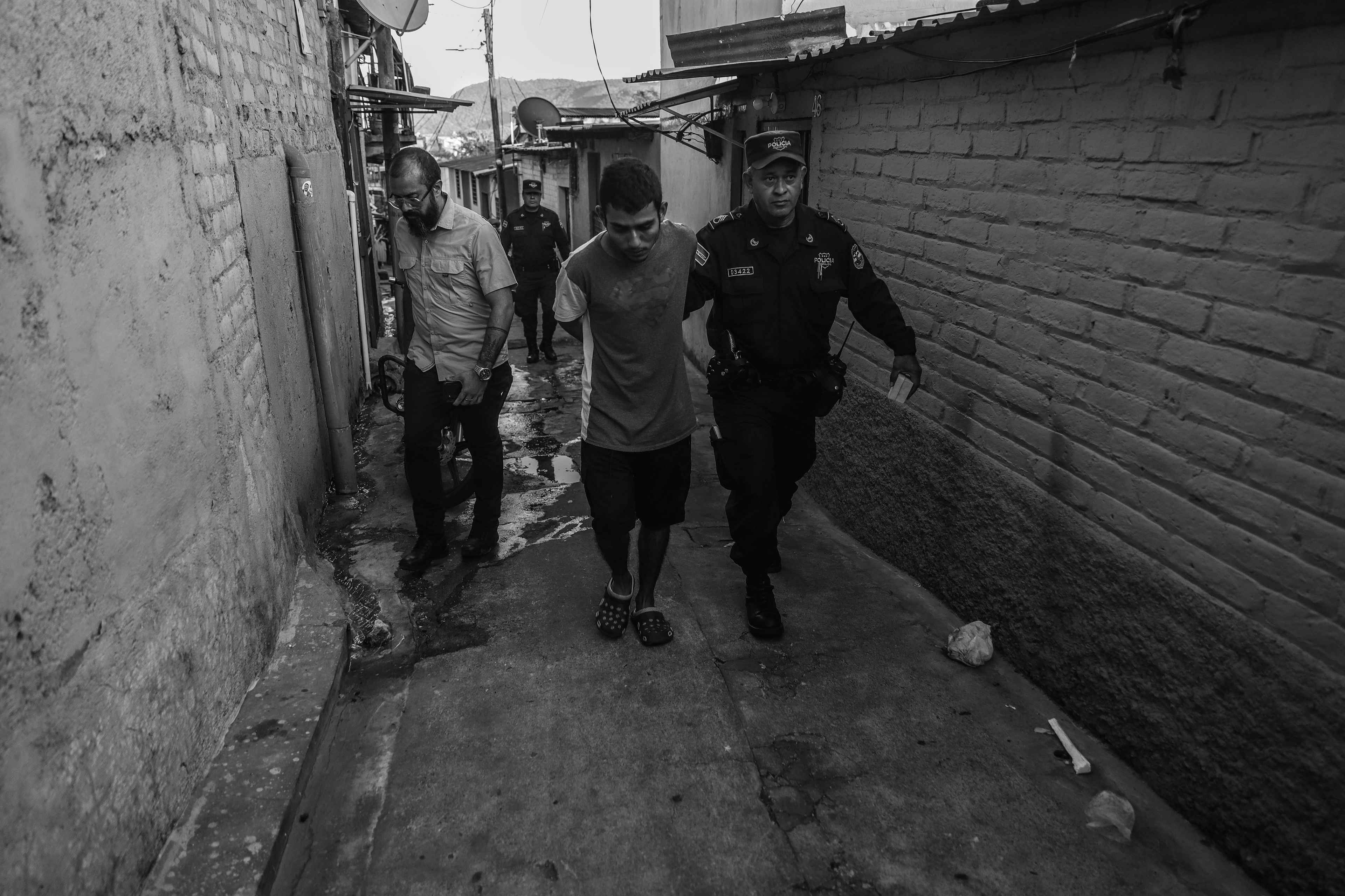 A young man is taken to prison by the police during an operation on Feb. 1, 2024, in the Nuevo Israel community of San Salvador. A bit of marijuana was found on him for personal consumption and he was treated as a gang member, despite having no links to criminal groups and no record of previous arrests.
