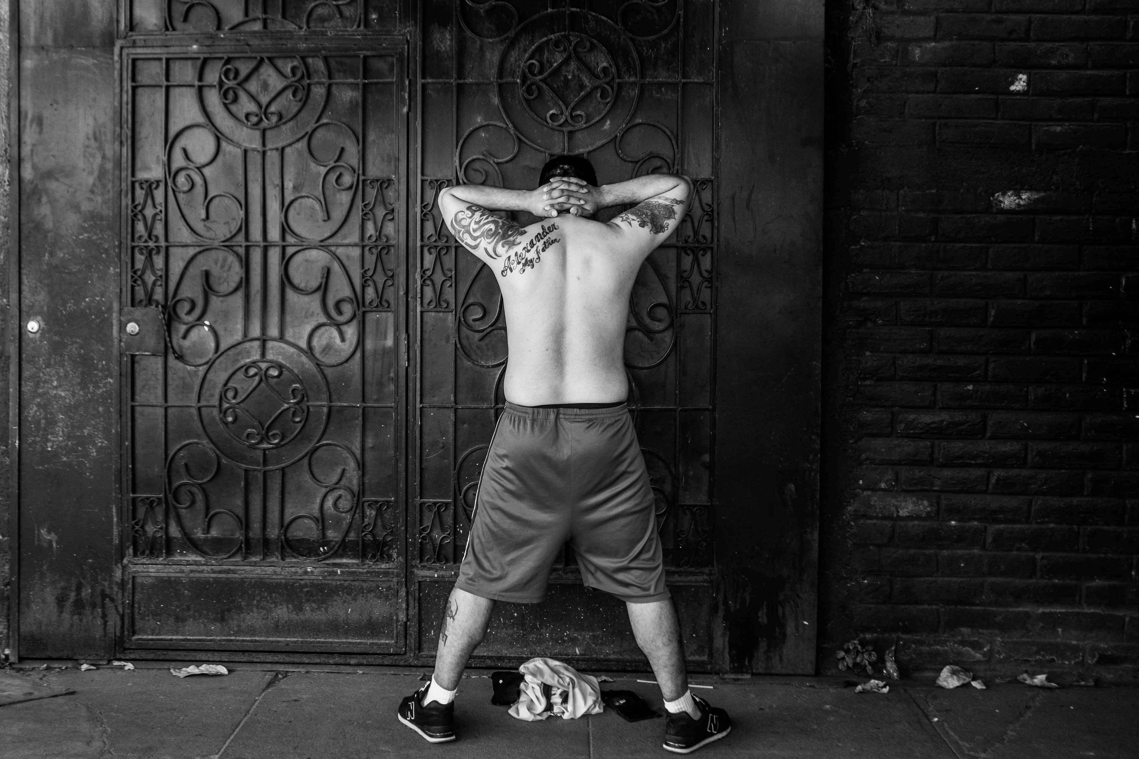 A man with tattoos that are not gang-related waits to be interrogated by soldiers on Dec. 3, 2022, during the military siege in Las Margaritas. According to human rights organizations, having tattoos was the reason why many were arrested during the country's state of exception.